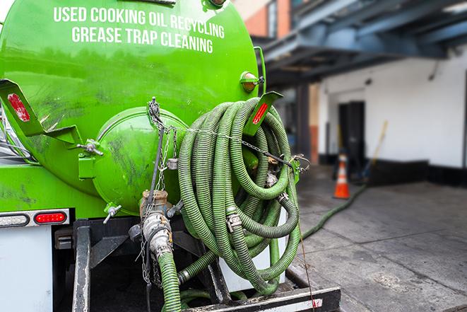 a technician pumping a grease trap in a commercial building in Culver City