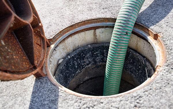 signs that a grease trap needs pumping include foul odors, slow drainage, and visible grease buildup